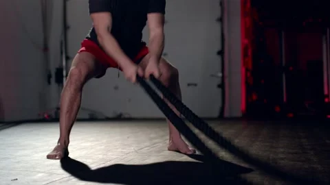 Assertive man doing exercises with battle rope, ruthlessly effective workout. Stock Footage 155660941