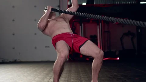 Assertive man doing exercises with battle rope, ruthlessly effective workout. Stock Footage 155661352