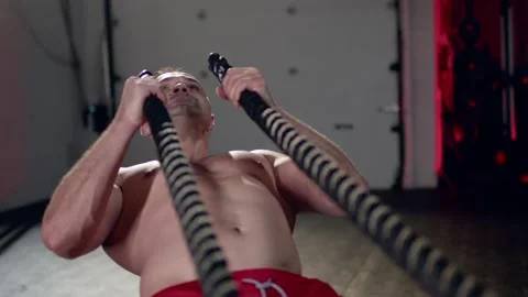 Assertive man doing exercises with battle rope, ruthlessly effective workout. Stock Footage 155661506