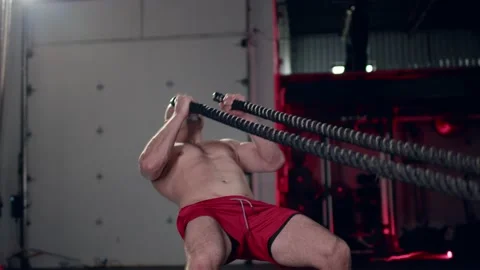 Assertive man doing exercises with battle rope, ruthlessly effective workout. Stock Footage 155661517