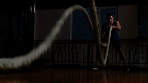 Assertive man making waves with battle ropes, pumping muscles and burning fat 스톡 동영상 121880654