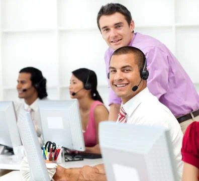Assertive manager checking his employee's work in Stock Photos
