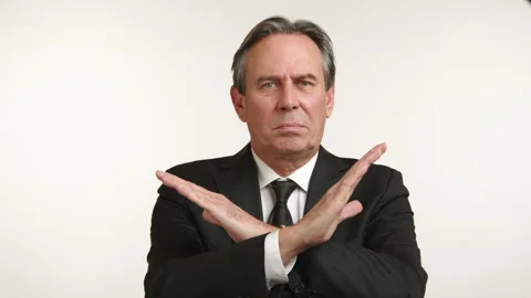 Assertive Middle-Aged Businessman with Crossed Arms Expresses Firm Disapproval 스톡 동영상 263151225