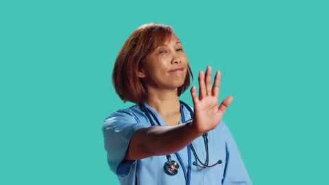 Assertive nurse throwing stop hand sign Stock Footage 246455218