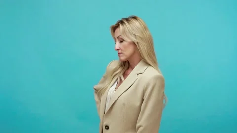 Assertive purposeful middle aged woman in business jacket doing shot, showing Stock Footage 137394777