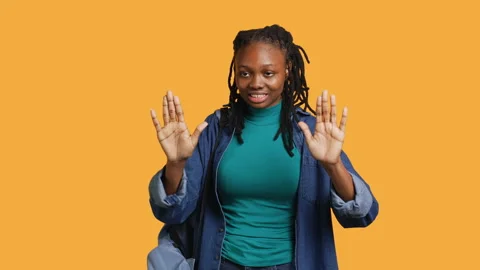 Assertive woman doing stop hand gesture, studio background Stock Footage 273834147