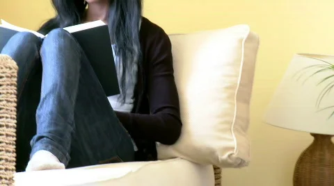 Assertive woman reading a book sitting on sofa Video stock 638202