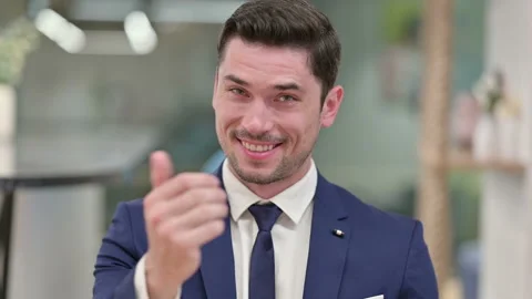 Assertive Young Businessman with Pointing and Inviting Stock Footage 135692483