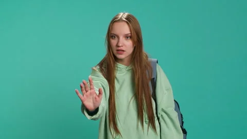 Assertive young woman doing stop hand gesture Stock Footage 276583294
