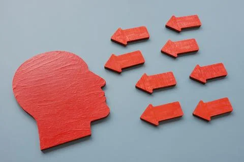 Assertiveness and confidence concept. Head shape and arrows. Stock Photos