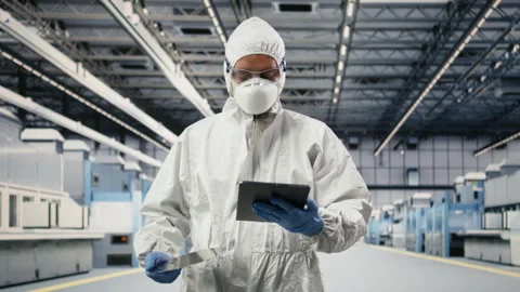 Assessing hardware fabrication, tablet and technician in microchip foundry lab Stock Footage 333392076