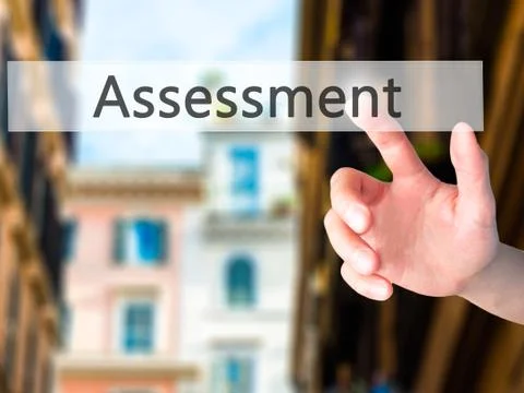 Assessment  - Hand pressing a button on blurred background concept on visual  Stock Photos