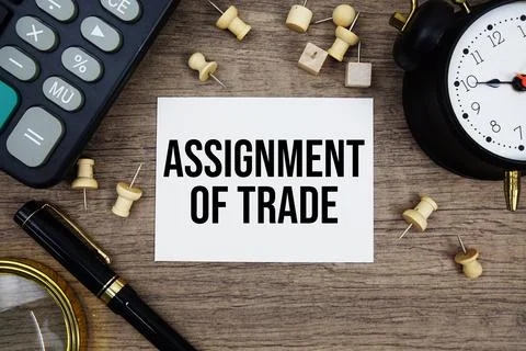 Assignment Of Trade text written on notepad with pen, alarm clock, magnifyi.. Stock Photos