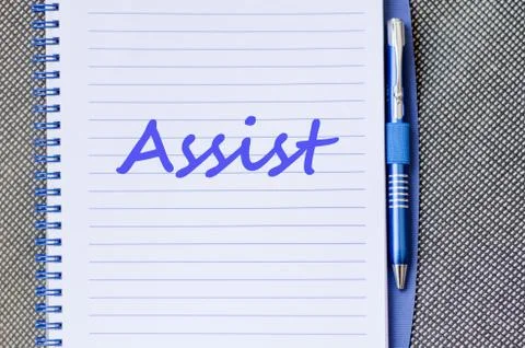 Assist write on notebook Stock Photos