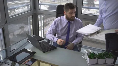 Assistant brings director documents, contract to sign, in work, in office 库存影片 73170321