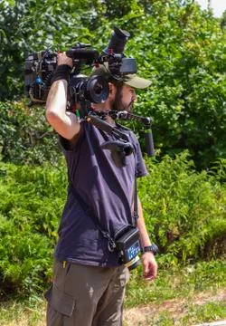Assistant cameraman with camera. Stock Photos