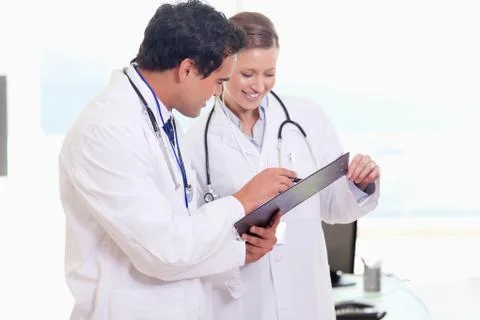 Assistant doctors reading off clip board Stock Photos