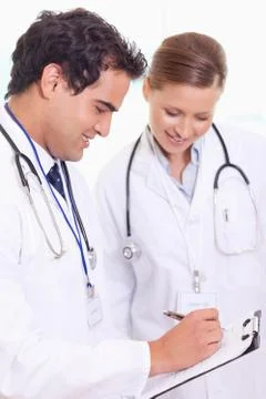 Assistant doctors taking notes Stock Photos