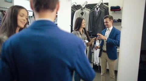 Assistant helps to a customer choose a tie Stock Footage