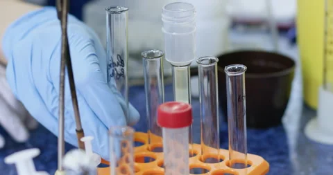 Assistant inserts pipette with liquid into test tube in lab 動画素材 274139000