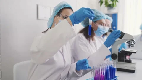 Assistant with laboratory test tubes Stock Footage 230439907