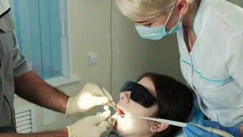 Assistant oversees work treating of dentist in dental clinic office Video stock 71628096