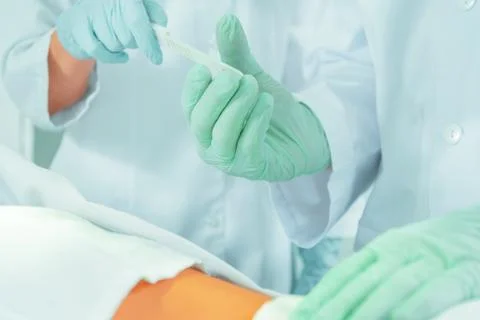 Assistant passes a scalpel Stock Photos
