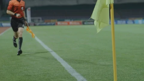 Assistant referee linesman moving along the sideline during a soccer match, 4k Stock Footage 89662231
