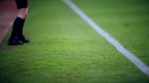 Assistant referee moving along the sideline during a soccer match Vidéo 73512232