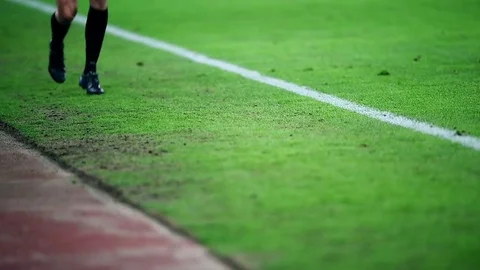 Assistant referee moving along the sideline during a soccer match Vídeo Stock 73512287