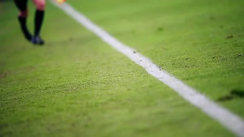 Assistant referee moving along the sideline during a soccer match Stock Footage 73512345