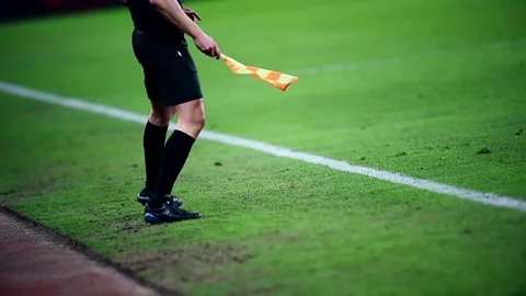 Assistant referee moving along the sideline during a soccer match Видео 73908232
