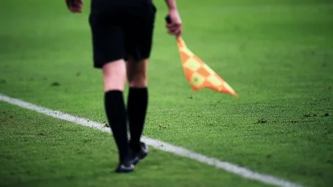 Assistant referee moving along the sideline during a soccer match Stockbeeldmateriaal 73908237