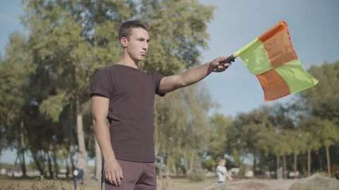 Assistant referee raising flag for offside trap Stock Footage 117099880