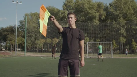 Assistant referee signalling offside offence trap Stock Footage 116968582