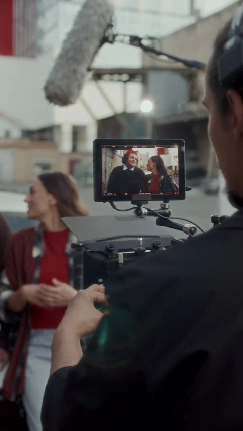 Assistant Slating Clapperboard and Camera Operator Shooting Scene on Set 스톡 동영상 336700132