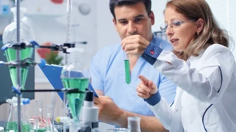Assistant is taking notes from a senior biotechnologist Stock-Footage 111811776