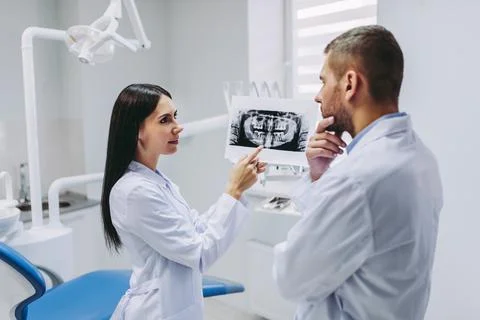 Assistant talking with thoughtful doctor Stock Photos