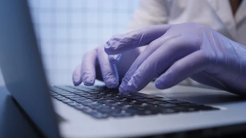Assistant works on computer in coronavirus researching lab Stock Footage 125930319