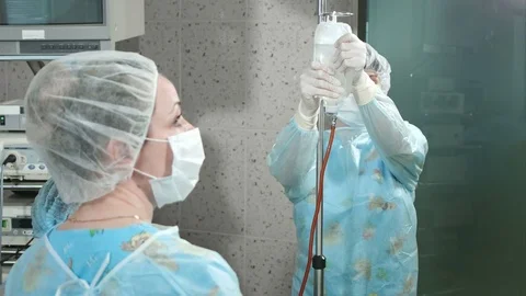 Assistants preparing for surgery in an operating room Stock Footage 80081505