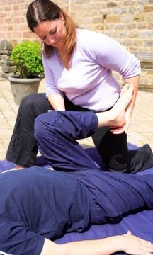 Assisted leg stretch Stock Photos