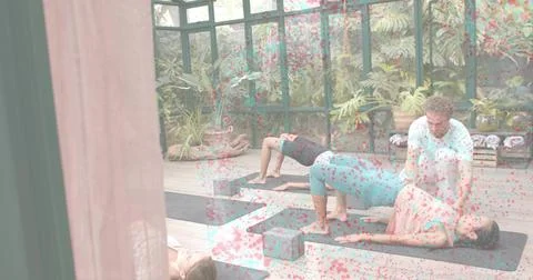 Assisting instructor adjusting student wearing pink top in glass studio, using Stock Photos