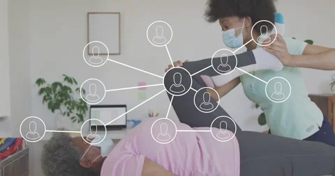 Assisting patient with leg exercise, physical therapist using network Stock Footage 305863181