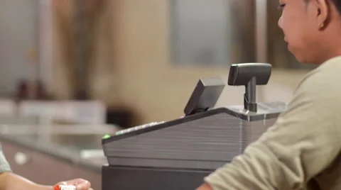 Associate at marijuana shop ringing up a purchase with a debit or credit card Video stock 59171933