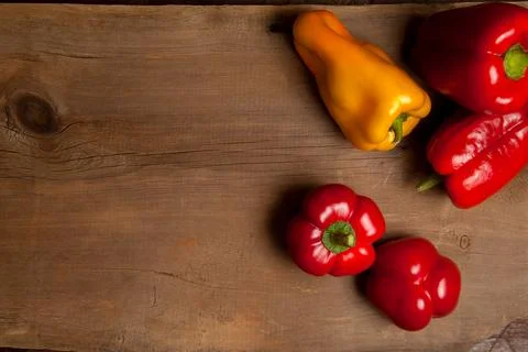 Assort of different shape and color bell pepper on wooden background.. Stock Photos