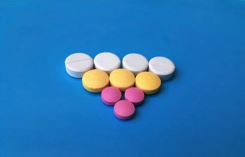 Assortative triangular pattern of med pills and capsules Stock Photos