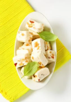 Assorted appetizers with basil garnish on plate Stock Photos