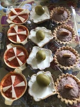 Assorted appetizers on puff pastry tartlets Stock Photos