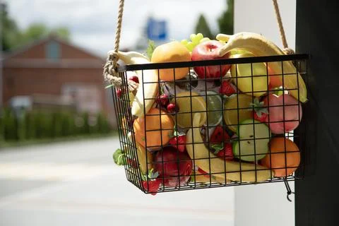 Assorted artificial fruits as decor element . Basket filled with artificial.. Stock Photos