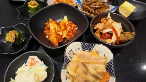 Assorted Asian Side Dishes and Hamburger Steak with Fried Egg Stock Footage 340869041